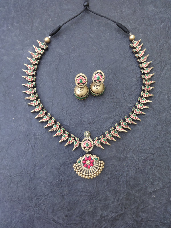 Jewelry set with necklace and earrings on a dark textured background