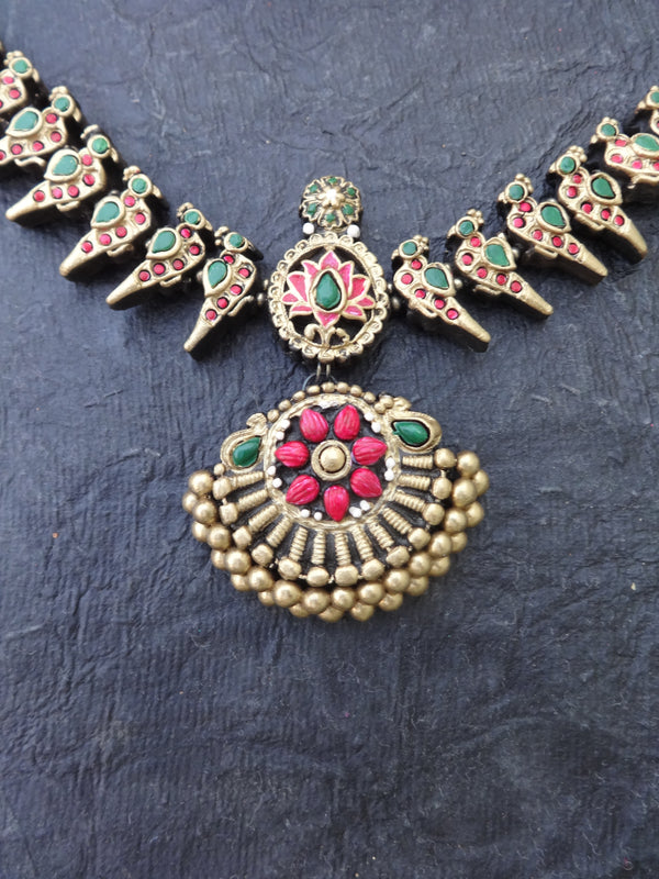 Decorative necklace with floral design on a dark textured background