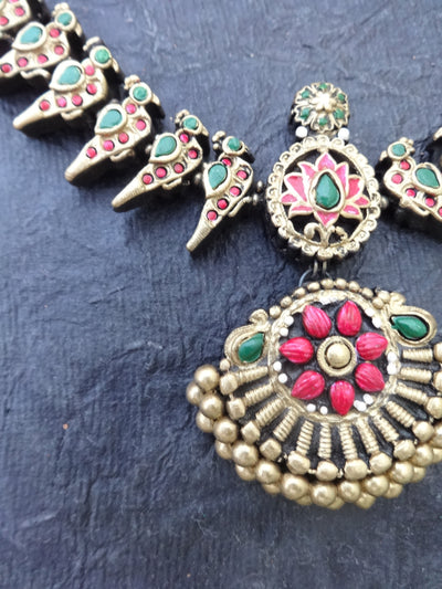 Ornate earrings with floral design on a blue background