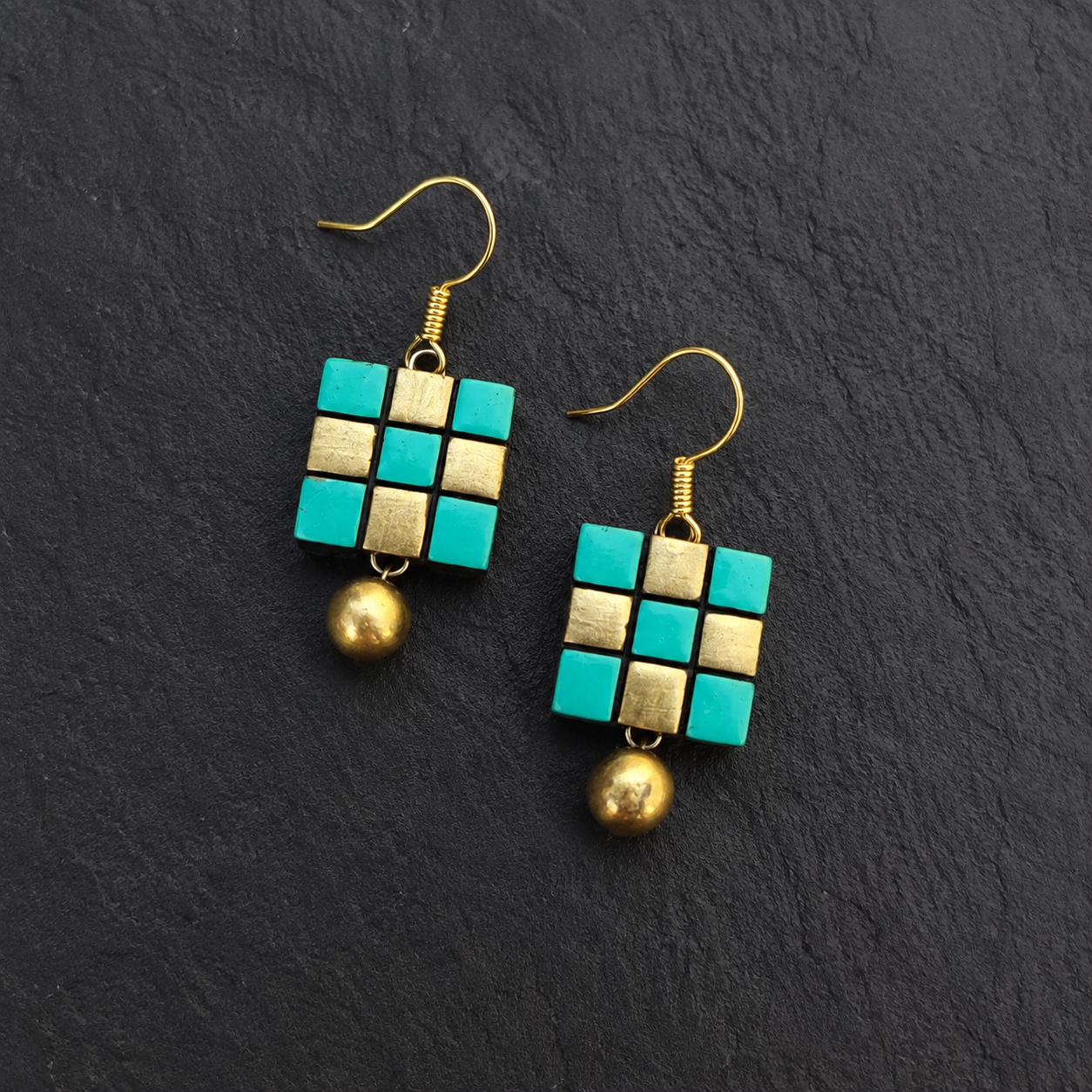 Handcrafted turquoise and gold geometric grid terracotta jewellery drop earrings with metallic beads on black slate